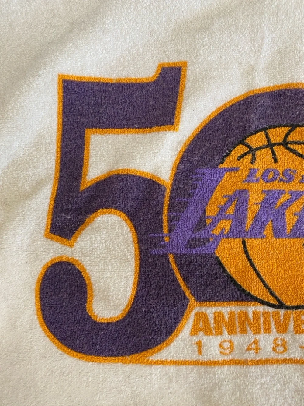 Los Angeles Lakers 50th anniversary towel with team's commemorative logo.